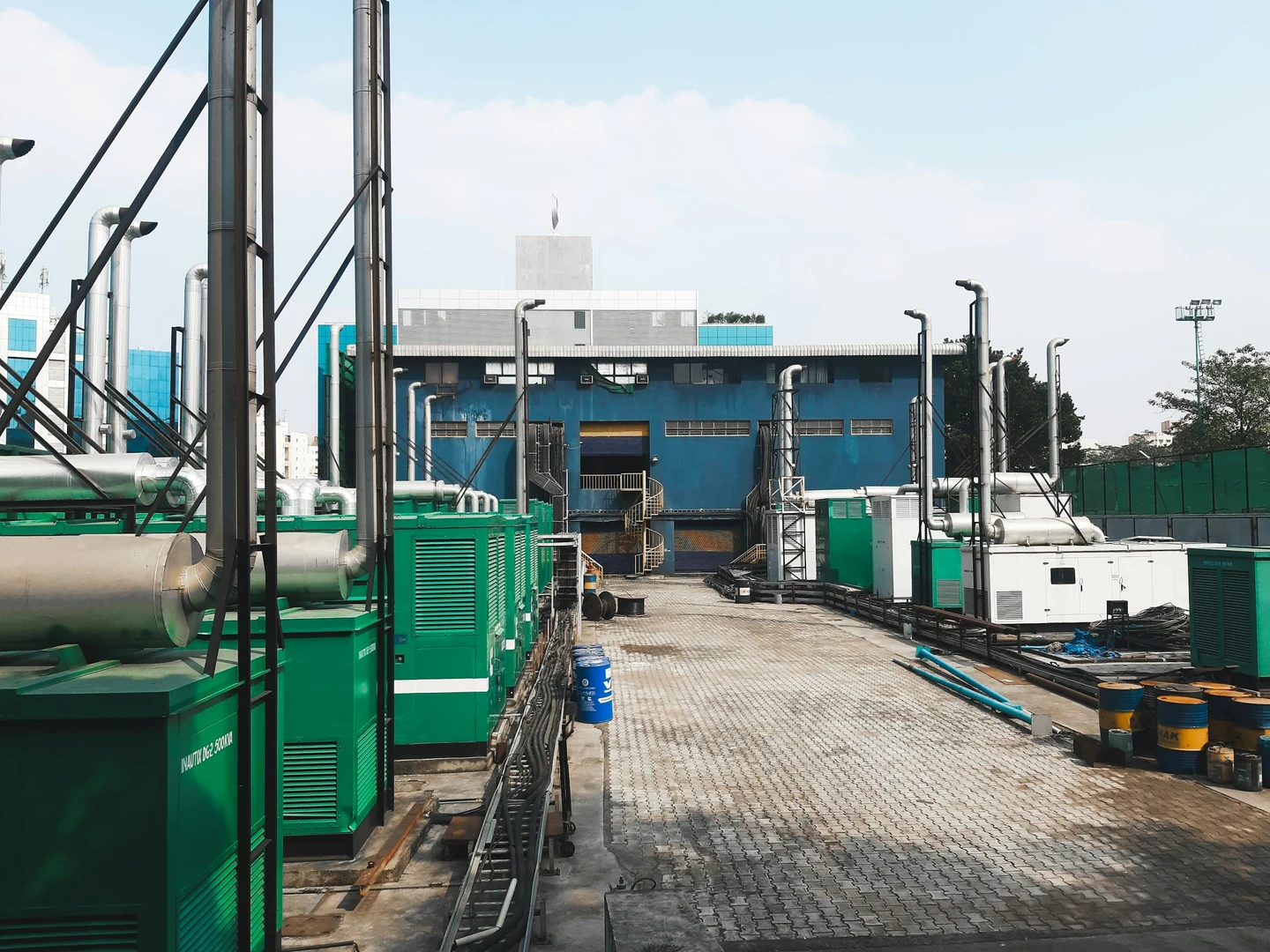 Enclosed generator sets and exhaust stacks at an industrial facility