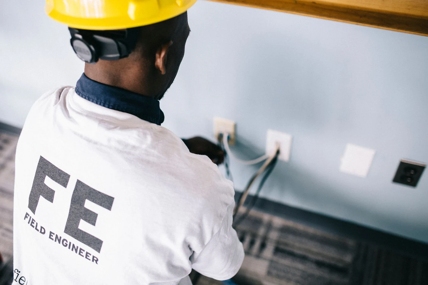 Electrician working near wall outlets